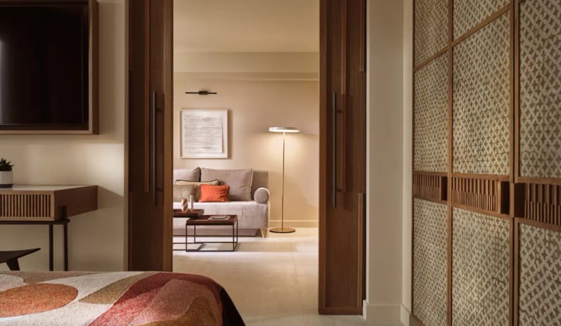 Deluxe Suite Garden View living area featuring warm ambient lighting, contemporary furniture, and elegant wood partitions at Eagles Palace by Kenwood Travel