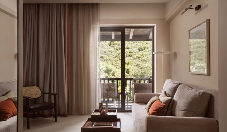 Deluxe Suite Garden View living area featuring warm ambient lighting, contemporary furniture, and elegant wood partitions at Eagles Palace by Kenwood Travel