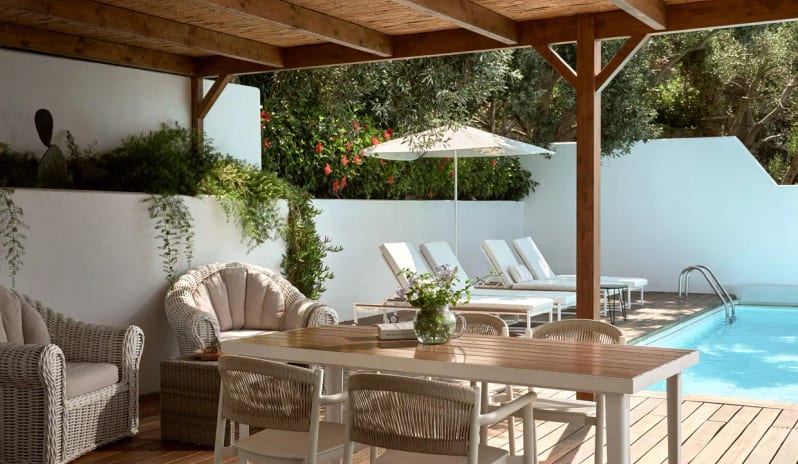 Presidential Bungalow private swimming pool, white sun loungers under an umbrella, and a shaded wooden dining area with wicker seating at Eagles Palace by Kenwood Travel