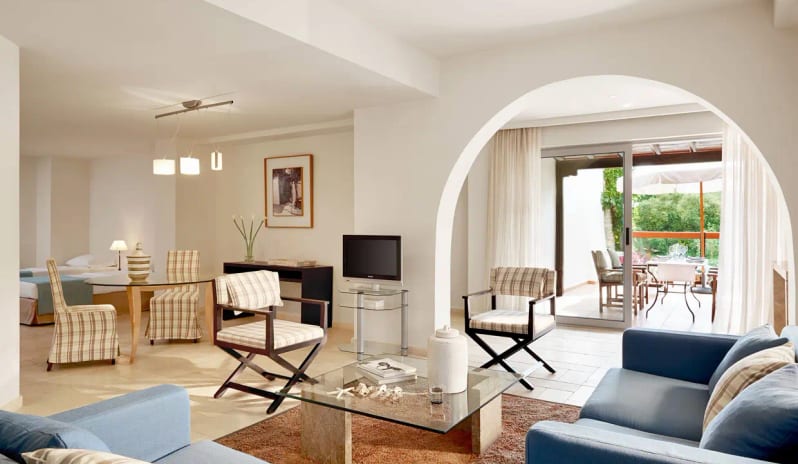 Two Bedroom Suite Garden View modern furniture, an arched doorway, and a glass sliding door leading to a private terrace with outdoor dining at Eagles Palace by Kenwood Travel