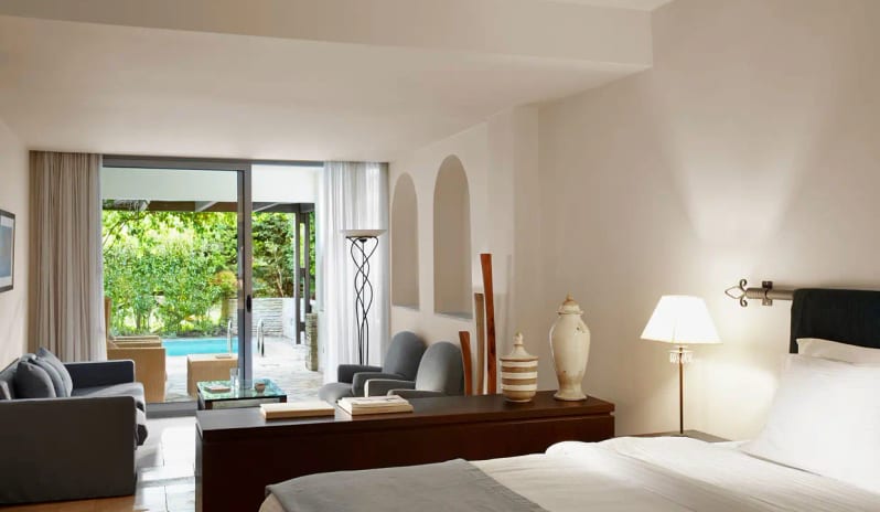 Two Bedroom Suite Garden View Private Pool living area, bedroom, and floor-to-ceiling glass doors leading to a private pool and garden at Eagles Palace by Kenwood Travel