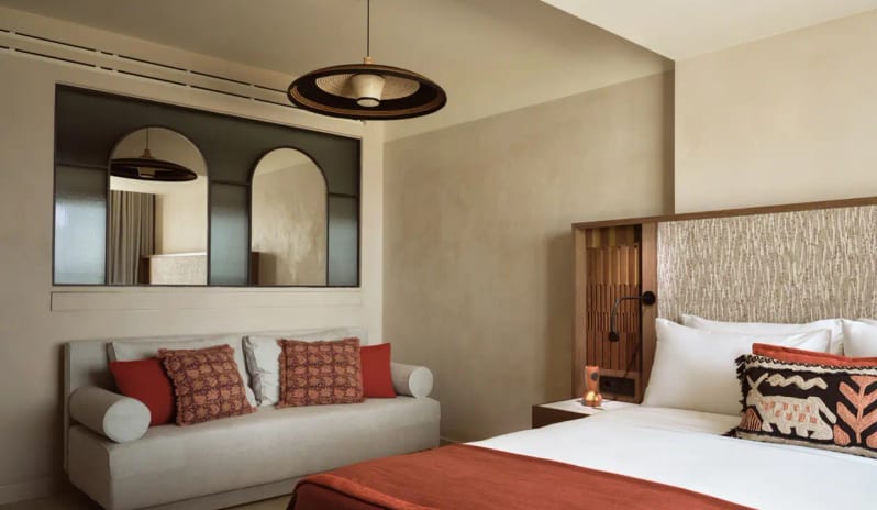Deluxe Junior Suite Sea Front modern sofa with terracotta pillows and unique Mediterranean decor at Eagles Palace by Kenwood Travel
