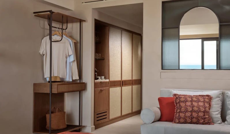 Deluxe Junior Suite Sea Front open wardrobe, integrated mini-bar, and stylish Mediterranean decor at Eagles Palace by Kenwood Travel