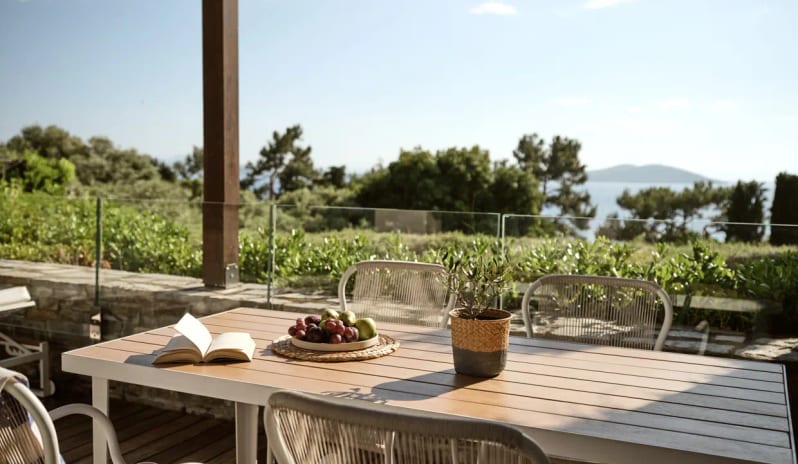 Junior Pool Villa Sea View featuring a minimalist desk with books and a decorative vase at Eagles Villas by Kenwood Travel
