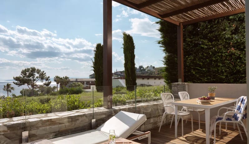 Junior Pool Villa Sea View featuring a minimalist desk with books and a decorative vase at Eagles Villas by Kenwood Travel