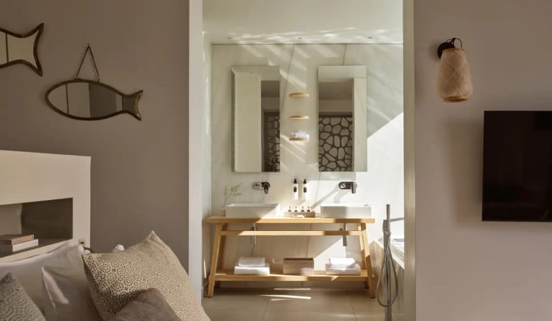 Junior Pool Villa Private Garden Sea View bathroom and bedroom suite at Eagles Resort Halkidiki Junior Pool Villa, featuring double vanities and Mediterranean decor at Eagles Villas by Kenwood Travel