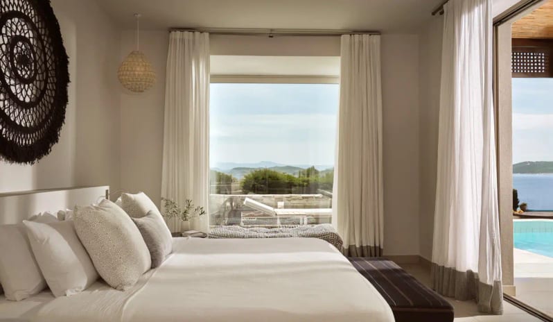 Ocean One Bedroom Pool Villa Sea View oceanfront bedroom at Eagles Resort Halkidiki featuring white linens, private pool view, and Mediterranean decor at Eagles Villas by Kenwood Travel