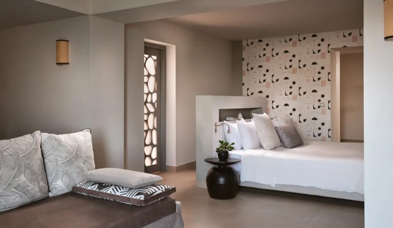 Residential 3 Bedroom Pool Villa Private Garden Sea View minimalist white bedding, and a separate lounge area with leaf-patterned cushions and ambient wall lighting at Eagles Villas by Kenwood Travel