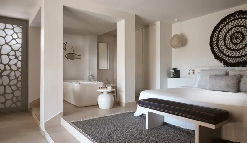 Residential 2 Bedroom Pool Villa Sea View Mediterranean interior design of a villa bedroom with white walls, a geometric patterned rug, and a private indoor bathtub at Eagles Villas by Kenwood Travel