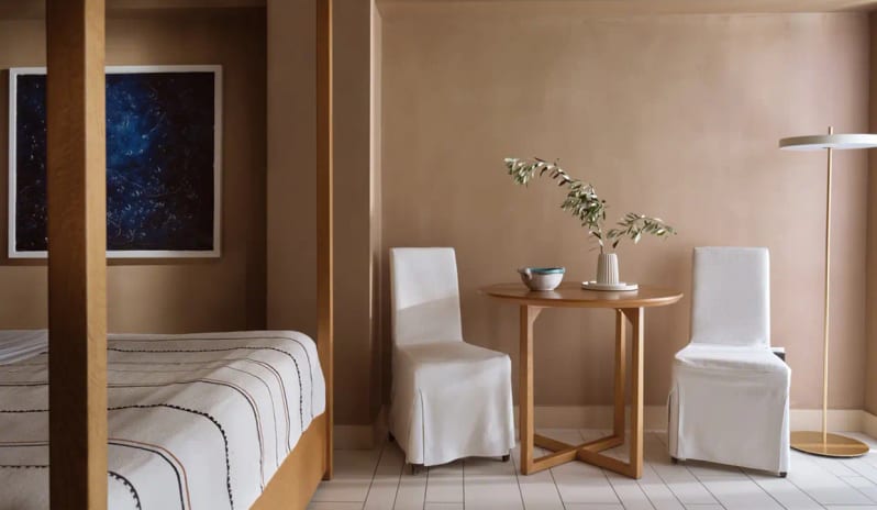 Bungalow Sea View bathroom double white vessel sinks, a wooden vanity, and sleek wall-mounted fixtures against warm ochre walls at Eagles Palace by Kenwood Travel