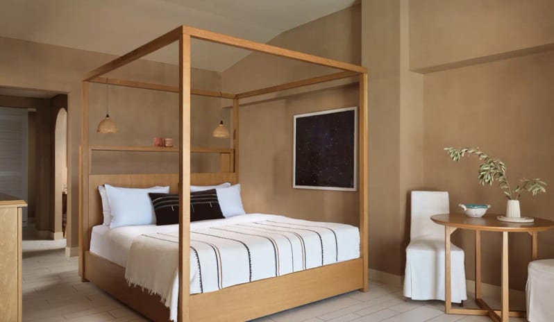 Bungalow Sea View Modern spa-style bathroom light wood canopy bed, minimalist earthy decor, and a small sitting area at Eagles Palace by Kenwood Travel