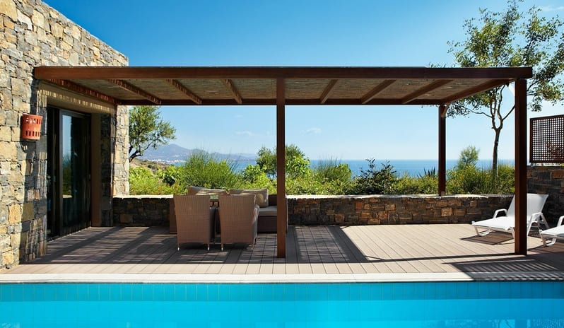 The Collection Premium Junior Suite with Private Pool Modern outdoor terrace with private pool, lounge seating, and panoramic sea view at a luxury resort at Daios Cove by Kenwood Travel