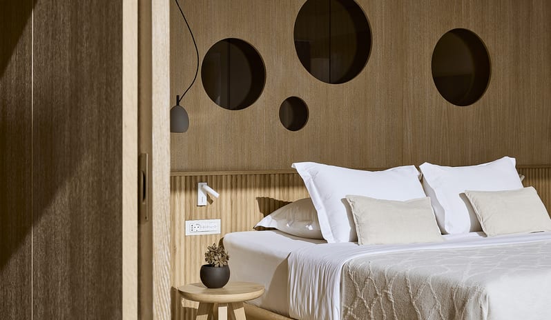Olives & Sea Two Bedroom Suite Private Pool Harbour View/Sea View interior detail of a luxury villa bedroom with custom light wood paneling, designer lighting, and geometric wall accents at St.Nicolas Bay Resort by Kenwood Travel