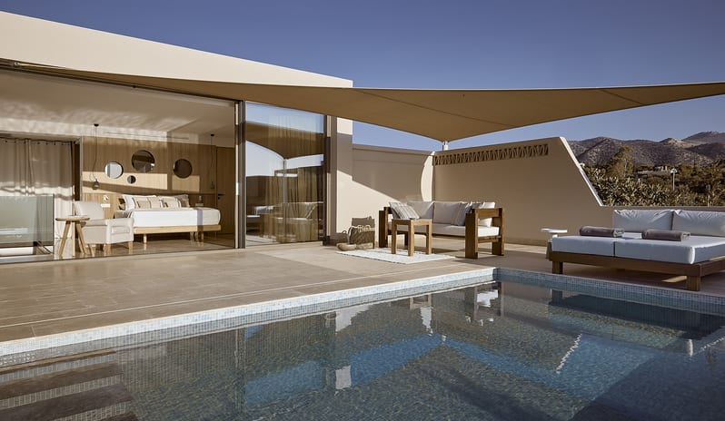 Olives & Sea Two Bedroom Suite Private Pool Harbour View/Sea View open-concept bedroom leading directly to a private pool terrace and shaded outdoor seating area at St.Nicolas Bay Resort by Kenwood Travel