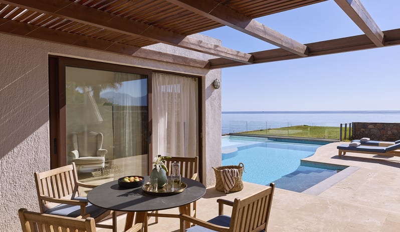 Club Suite One Bedroom Private Pool Sea View outdoor dining set on a private terrace with a wooden pergola, situated next to a private swimming pool with views of the Mediterranean horizon at St.Nicolas Bay Resort by Kenwood Travel