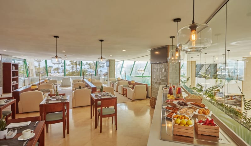 Preferred Club Lounge featuring an elegant interior, continental breakfast spread, and floor-to-ceiling windowsat Dreams Lanzarote Playa Dorada Resort & Spa by Kenwood Travel
