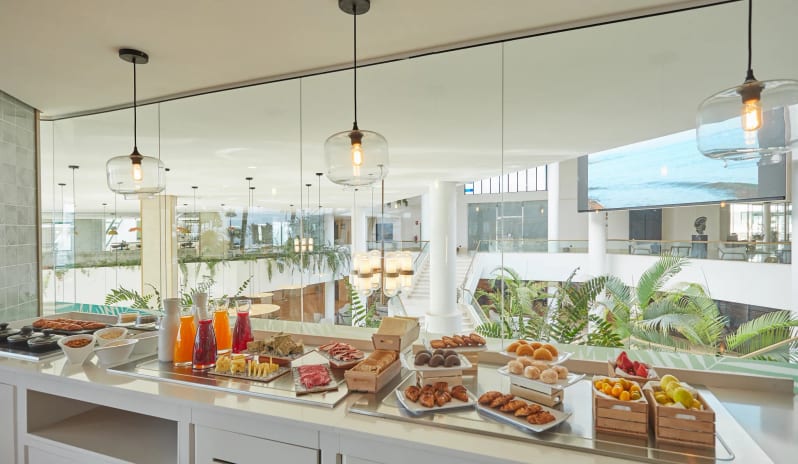 Preferred Club Lounge featuring an elegant interior, continental breakfast spread, and floor-to-ceiling windowsat Dreams Lanzarote Playa Dorada Resort & Spa by Kenwood Travel