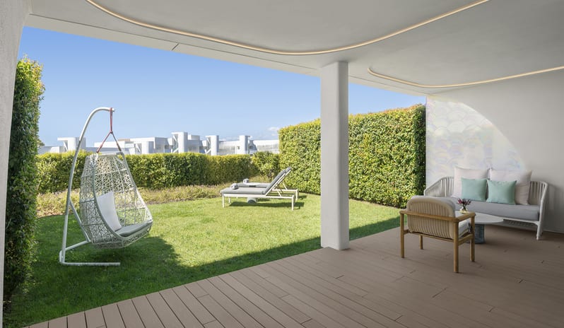 Superior Two Bedroom Suite featuring a private landscaped garden, wooden terrace with lounge seating, and a white hanging egg chair at W Algarve by Kenwood Travel