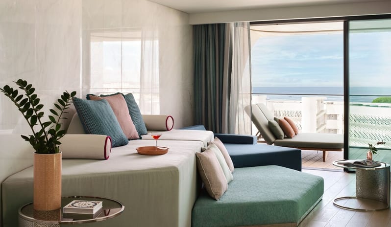 Penthouse II Suite, One Bedroom Suite with Pool lounge with a large modular daybed in pastel tones, overlooking a private balcony with a sea view and outdoor lounger at W Algarve by Kenwood Travel