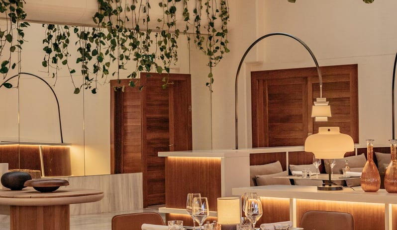 Paradisus Salinas Lanzarote Samira restaurant interior at Paradisus Salinas featuring cognac leather chairs and round wooden tables-Kenwood Travel