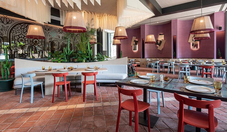 Gracias Mexican Restaurant purple curved walls, traditional sugar skull wall art, and modern dining furniture on terracotta tiles at Voyage Belek Golf & Spa by Kenwood Travel