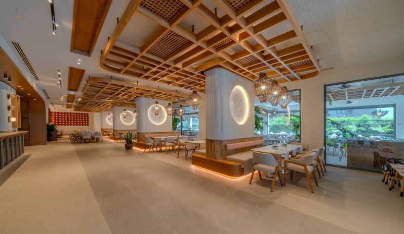 Myra Main Restaurant featuring light wood lattice ceilings and circular backlit wall art at Liberty Fabay by Kenwood Travel