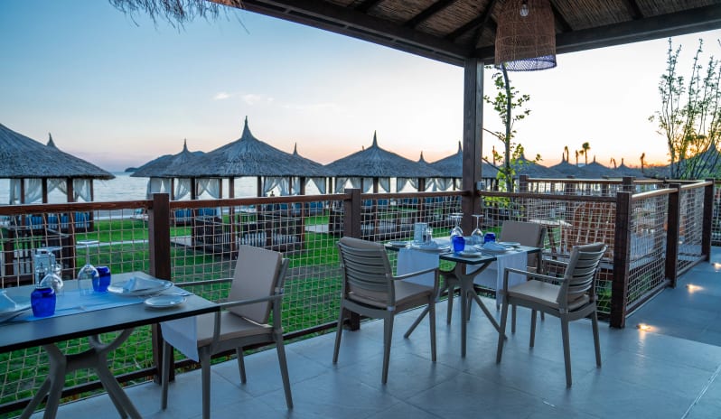 Mayta Peruvian & Seafood Restaurant Luxury seaside restaurant terrace with views of beach pavilions and the ocean during twilight at Liberty Fabay by Kenwood Travel