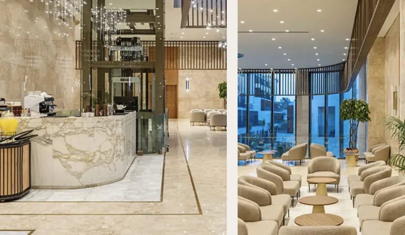 Ave Lobby Bar luxury lobby bar at Liberty Signa featuring a white marble counter, contemporary crystal chandeliers, and polished stone flooring at Liberty Signa Hotel by Kenwood Travel
