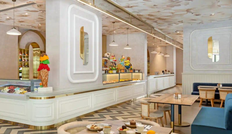 Bon Bon Patisserie floral ceiling wallpaper, chevron floors, and elegant cafe seating at Liberty Signa Hotel by Kenwood Travel