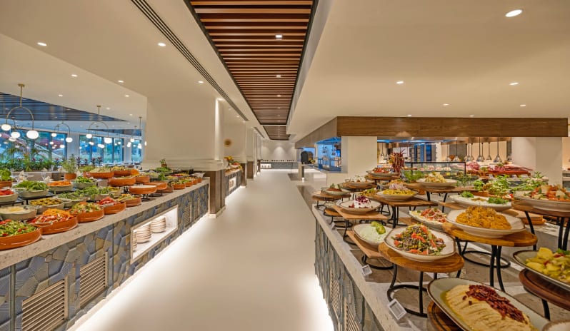 Myra Main Restaurant & Kids Buffet two rows of appetizers, fresh salads, and Mediterranean mezes in terracotta and ceramic bowls at Liberty Signa Hotel by Kenwood Travel