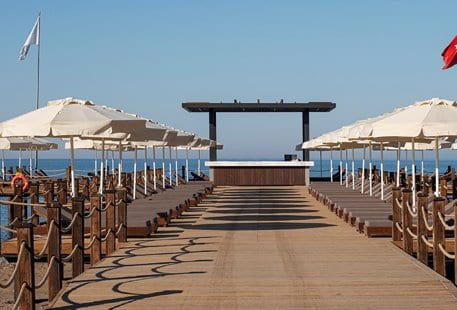 Pier Bar Luxury wooden family pier with sun loungers and white umbrellas at Voyage Belek Golf & Spa by Kenwood Travel