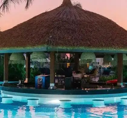 Lagoon Bar Swim-up bar with a thatched roof and underwater stools at Liberty Fabay by Kenwood Travel