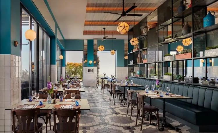 Carosello eal walls, geometric pendant lighting, and elegant bistro-style seating at Tivoli Alvor Algarve by Kenwood Travel