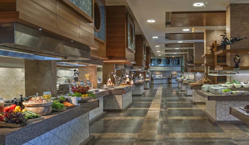Sarigerme Main Restaurant fresh produce stations and elegant wood-paneled interior design at Hilton Dalaman Sarigerme Resort & Golf by Kenwood Travel