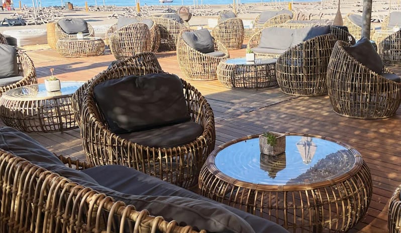 Beach Bar Luxury wicker lounge seating and glass tables overlooking the Mediterranean Sea in Turkey at Hilton Dalaman Sarigerme Resort & Golf by Kenwood Travel