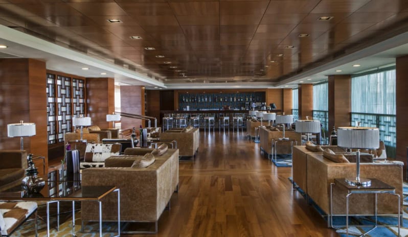 Pianoforte Bar wood-paneled ceilings, plush leather seating, and a long cocktail bar at Hilton Dalaman Sarigerme Resort & Golf by Kenwood Travel
