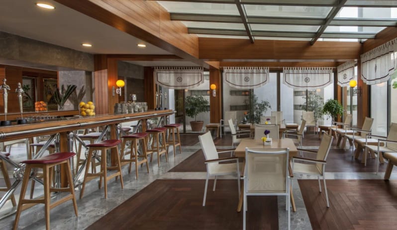Elysion Spa Vitamin Bar wood-paneled ceilings, a glass skylight, marble floors, and elegant seating at Hilton Dalaman Sarigerme Resort & Golf by Kenwood Travel
