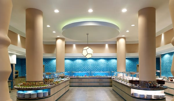 Main Restaurant Elegant resort dining hall showing a clean, symmetrical buffet layout with recessed ceiling lighting and architectural pillars at Xanadu Island by Kenwood Travel