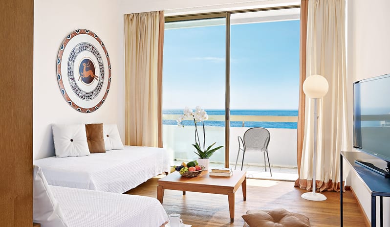 LUX ME Family Guestroom Sea View two twin beds, a private balcony with a sea view, and modern Greek-inspired decor at Grecotel LUXME Dama Dama by Kenwood Travel