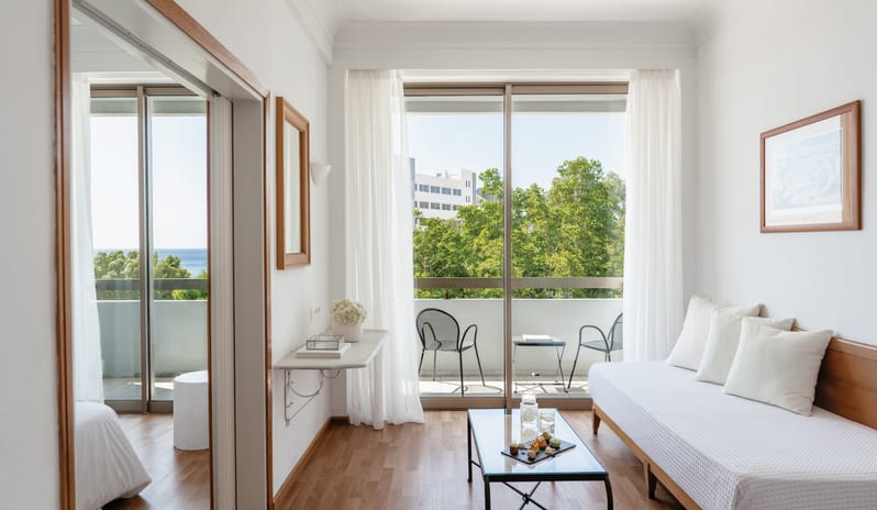 Premier Family Guestroom Side Sea View featuring a bright lounge area and a balcony with sea views at Grecotel LUXME Dama Dama by Kenwood Travel