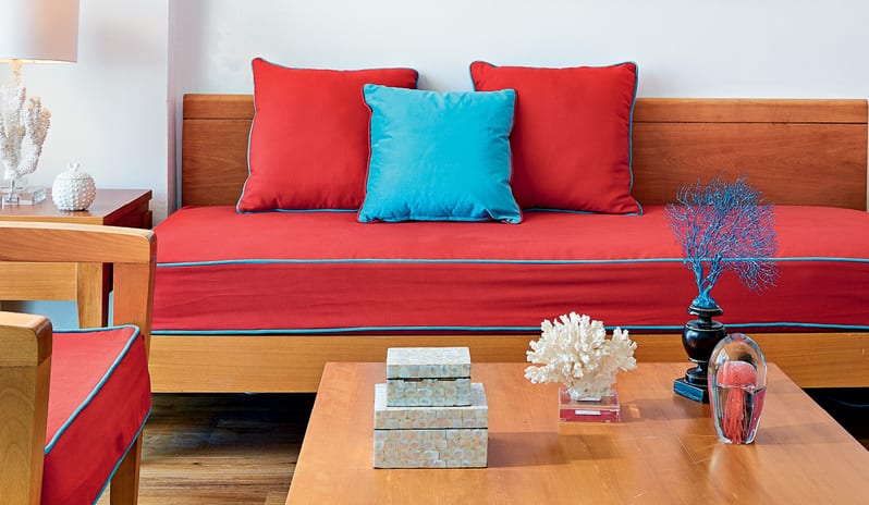 Superior Guestroom Sea View red sofa with turquoise accents and coral-inspired decor at Grecotel LUXME Dama Dama by Kenwood Travel