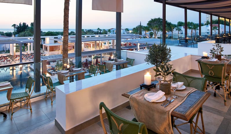 Italian à la Carte Romantic evening setting at an Italian restaurant with candlelit outdoor seating and Mediterranean resort viewsat Grecotel LUXME Dama Dama by Kenwood Travel