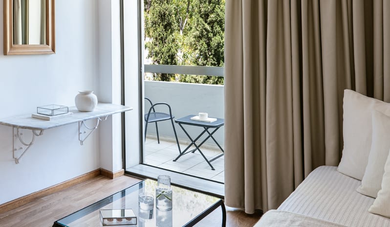 Family Guestroom Inland View Private balcony and living area of a family guestroom at Grecotel LUXME Dama Dama by Kenwood Travel