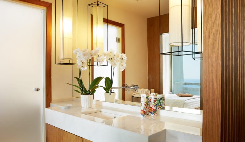 LUX ME Family Guestroom Sea View white marble countertops, designer lighting, and premium bath amenities at Grecotel LUXME Dama Dama by Kenwood Travel