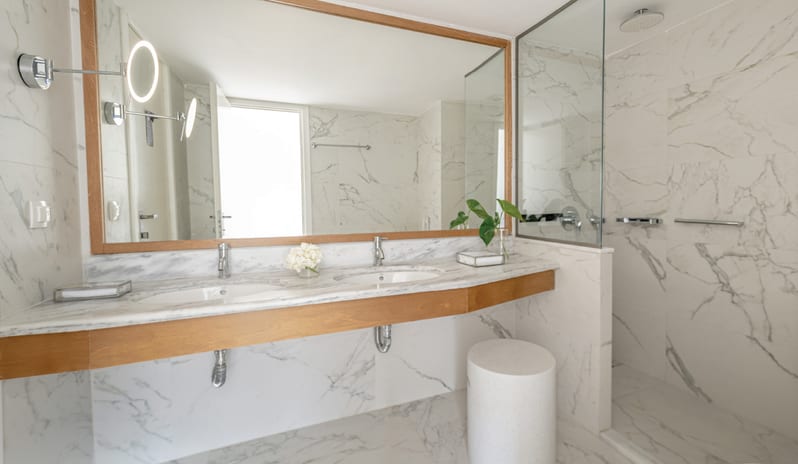 Premier Family Guestroom Side Sea View Upscale marble bathroom in a luxury family guestroom at Grecotel LUXME Dama Dama by Kenwood Travel