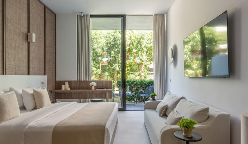 Premier Loft Family Guestroom private terrace view, neutral-toned decor, and minimalist luxury design at Grecotel LUXME Dama Dama by Kenwood Travel