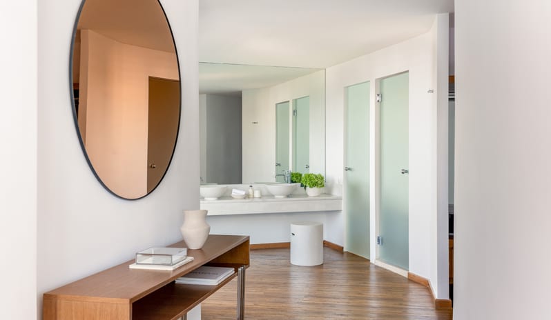 LUX ME Superior Guestroom Sea Viewopen-plan bathroom and vanity area round mirror and frosted glass doors at Grecotel LUXME Dama Dama by Kenwood Travel