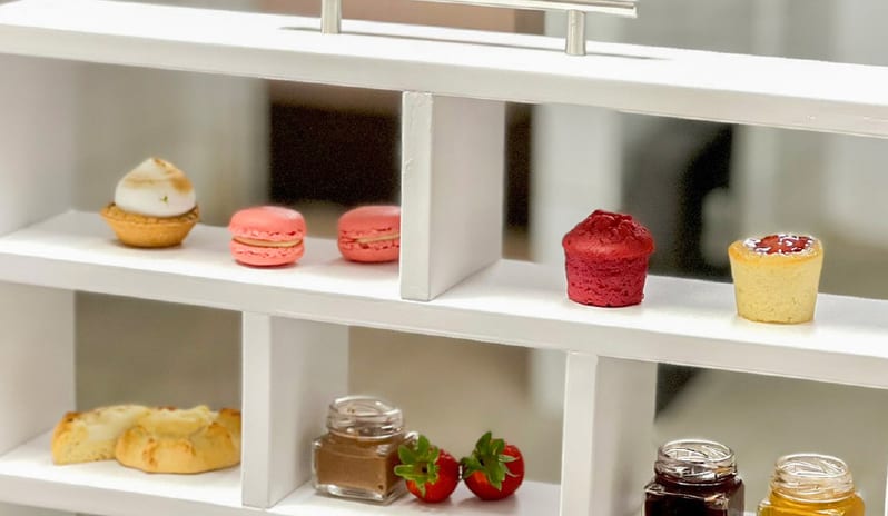 Patisserie & Chocolaterie featuring a white tiered display of macarons, mini tarts, finger sandwiches, scones, and artisanal jams at Grecotel LUXME Dama Dama by Kenwood Travel