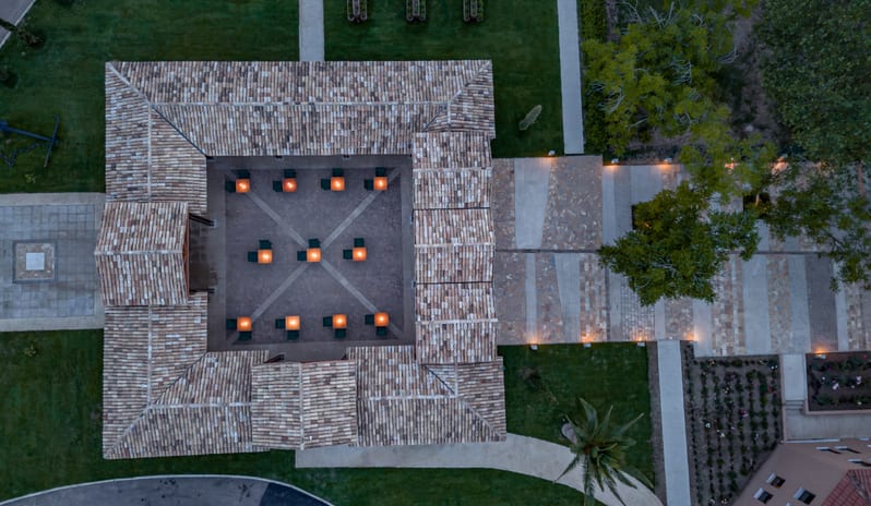 Botanica Fine Dining Aerial view of the illuminated outdoor fine dining courtyard at Grecotel LUXME Costa Botanica by Kenwood Travel