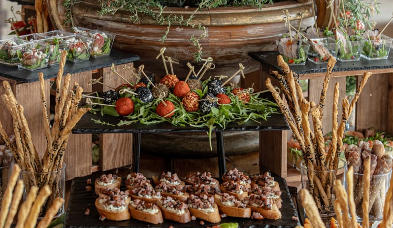 Mediterranea Mediterranean buffet with fresh tomato bruschetta, gourmet cheese, breadsticks, and appetizers at Grecotel LUXME Costa Botanica by Kenwood Travel